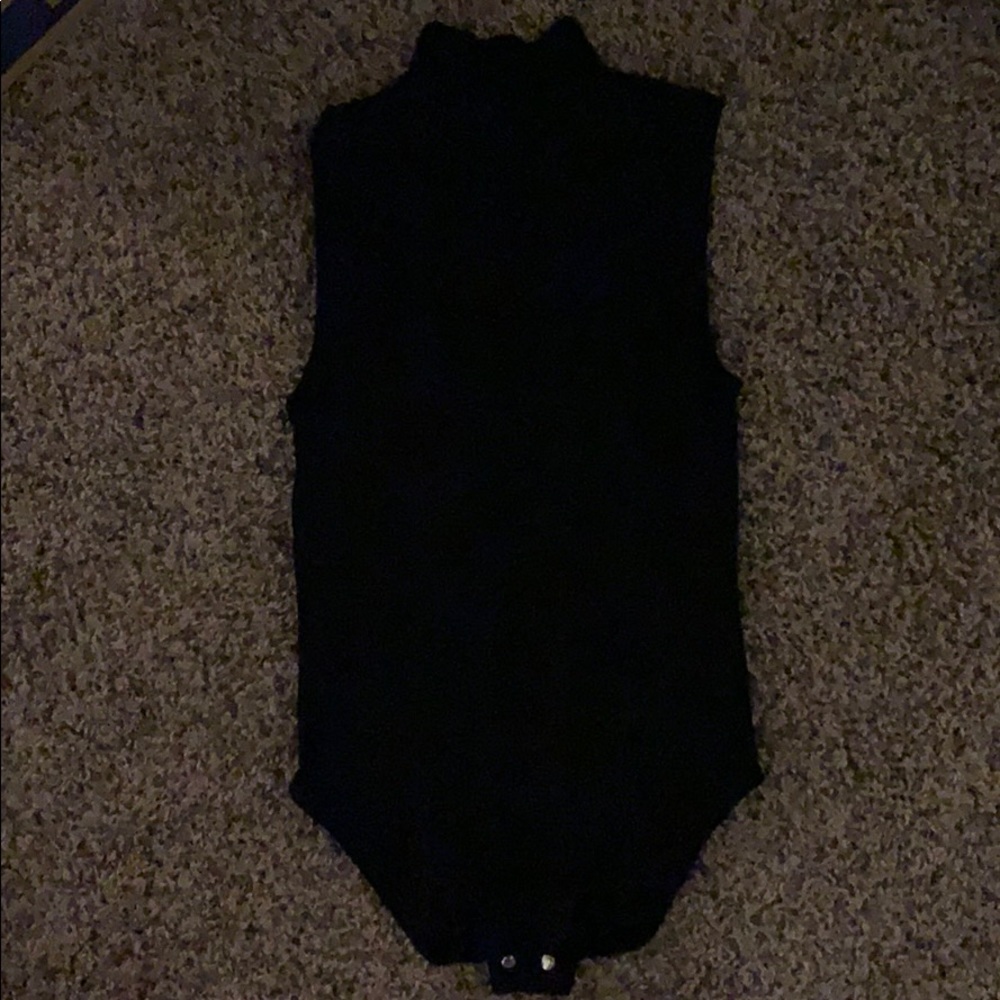 Black top that is supposed to be tucked in